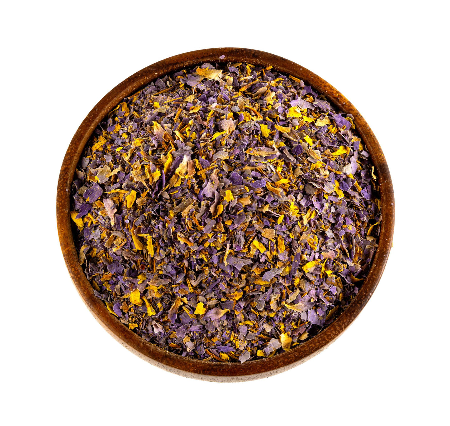 A top-down view of dried blue lotus flower petals and small yellow stamens inside a round wooden bowl, isolated on a white background.