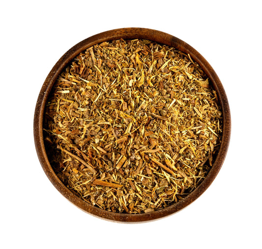 A top-down view of loose kanna inside a round wooden bowl, set against a solid white background.