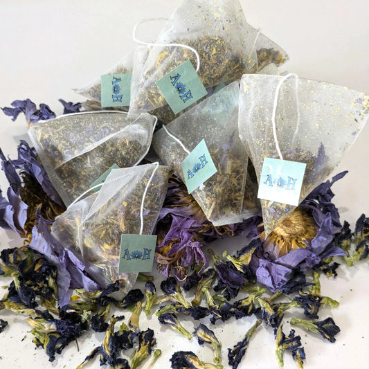 Tea bags with butterfly pea flowers and blue lotus on a white background by Astral Herbal