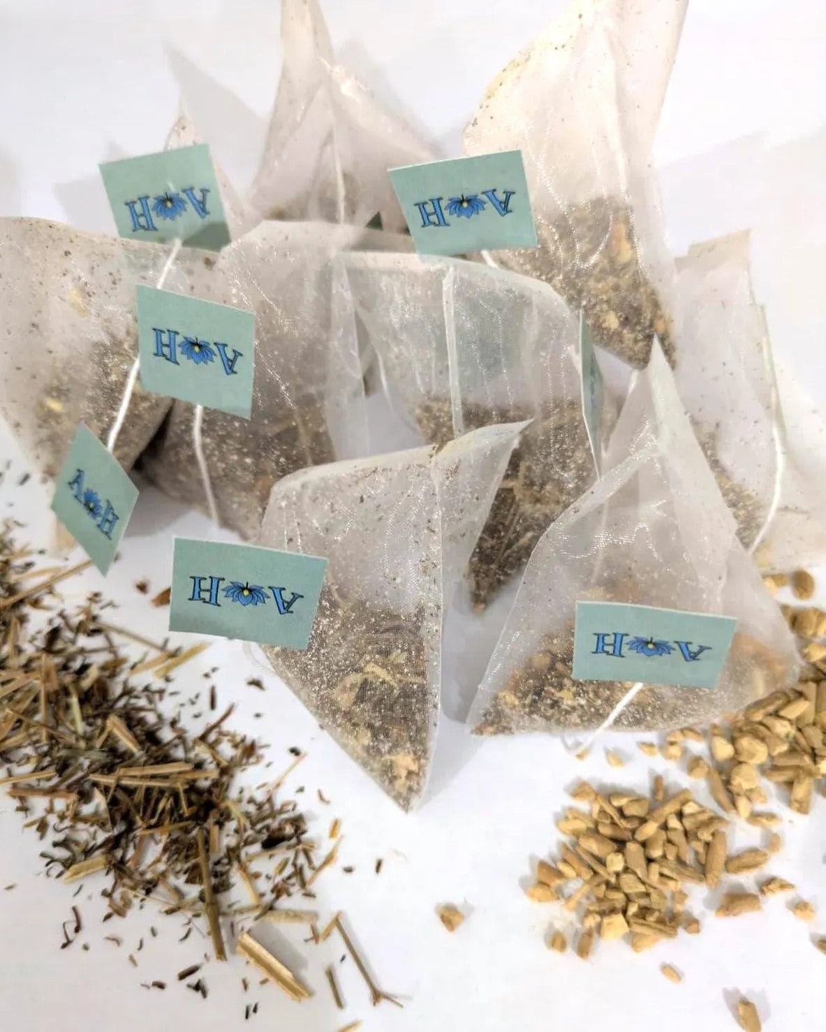 Astral Herbal tea bags on a white background with St. John's Wort and Ashwaghanda in the foreground.