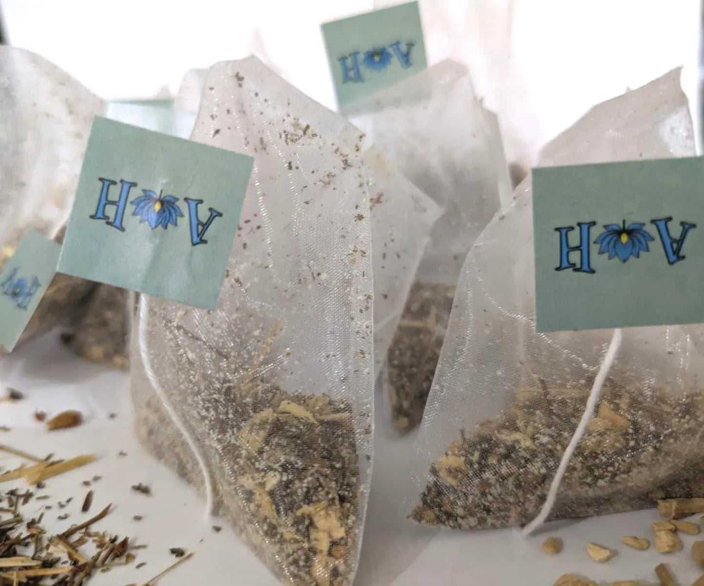 Astral Herbal tea bags on a white background with St. John's Wort and Ashwaghanda in the foreground.