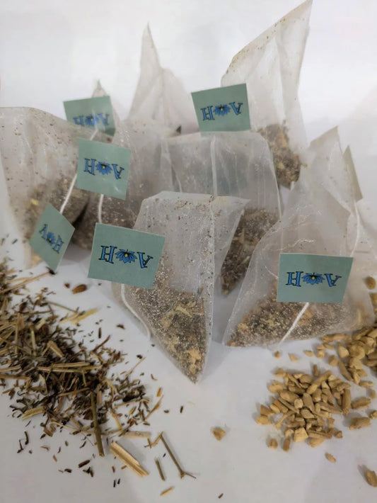 Astral Herbal tea bags on a white background with St. John's Wort and Ashwaghanda in the foreground.