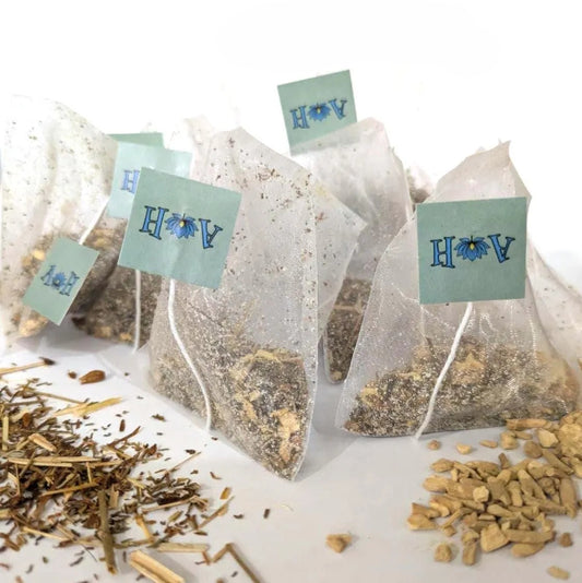 Astral Herbal tea bags on a white background with St. John's Wort and Ashwaghanda in the foreground.