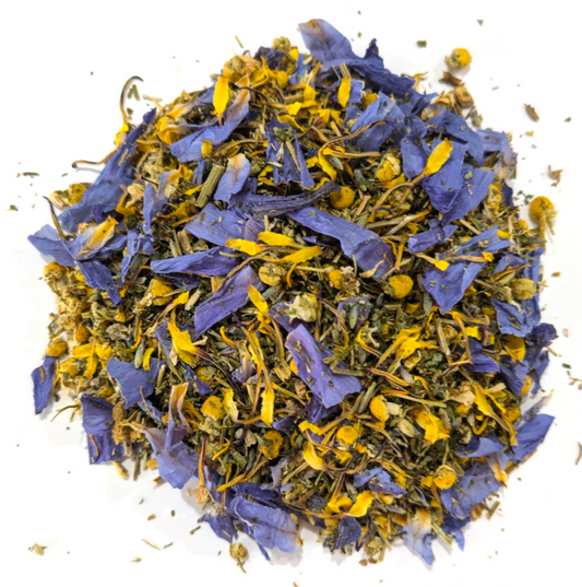 Dried blue lotus petals, chamomile, and california poppy by Astral Herbal on a white background.