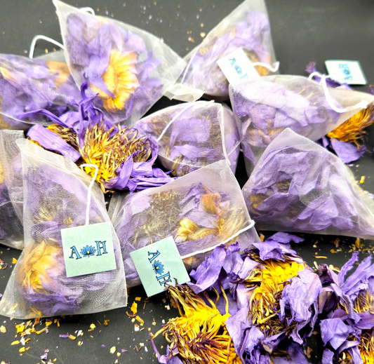 Blue lotus pyramid tea bags by Astral Herbal on a black background.