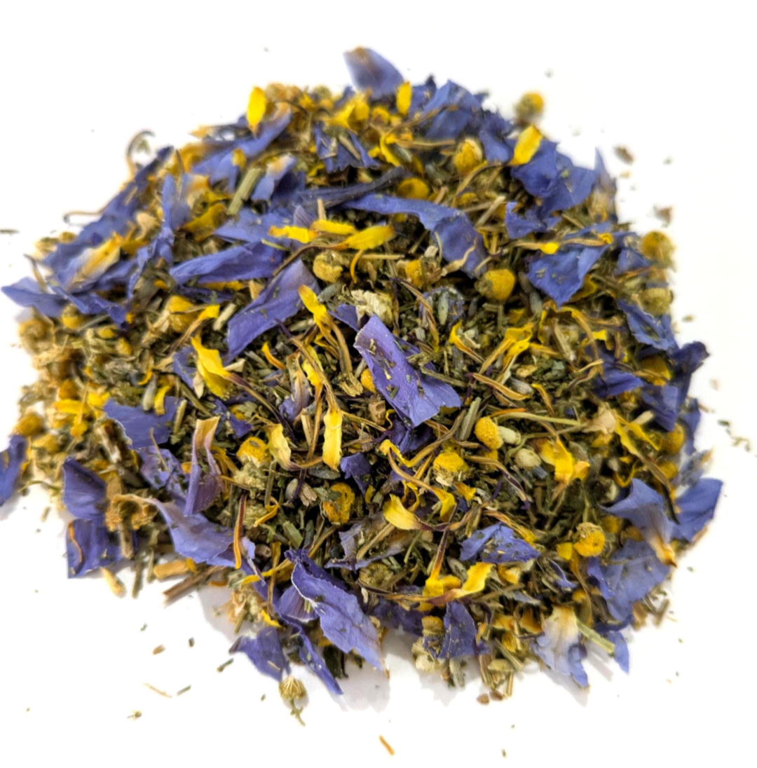 Dried blue lotus petals, chamomile, and california poppy by Astral Herbal on a white background.