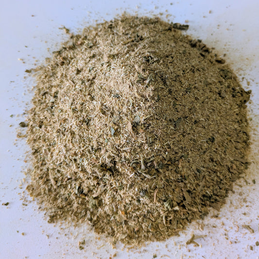 Close-up of a pile of greenish-brown kanna on a white background