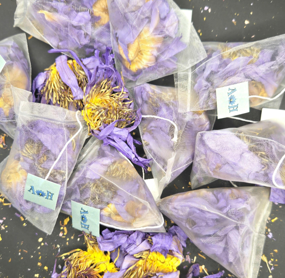 Blue lotus pyramid tea bags by Astral Herbal on a black background.