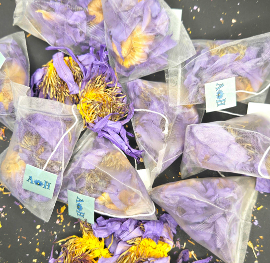Blue lotus pyramid tea bags by Astral Herbal on a black background.