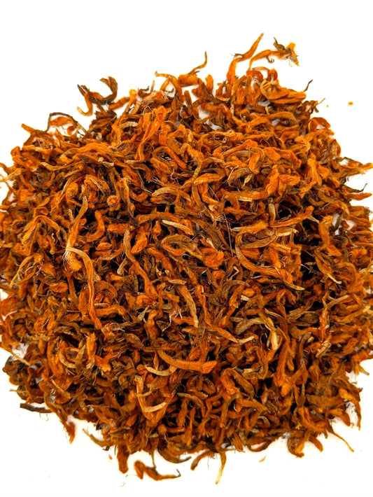 A mound of dried wild dagga flower by Astral Herbal on a white background.