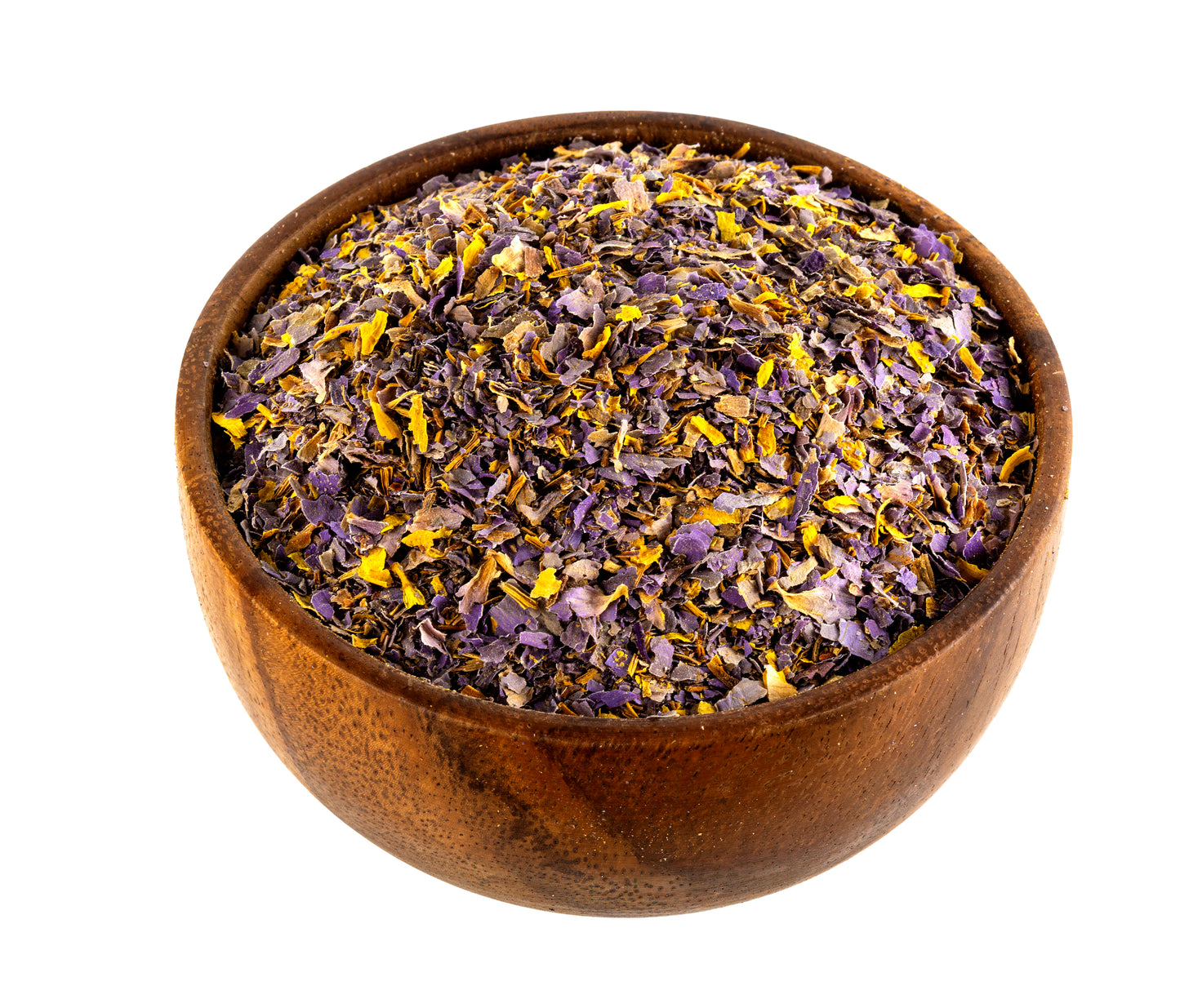 A wooden bowl filled with loose dried blue lotus flower petals, primarily purple and yellow, isolated on a white background.