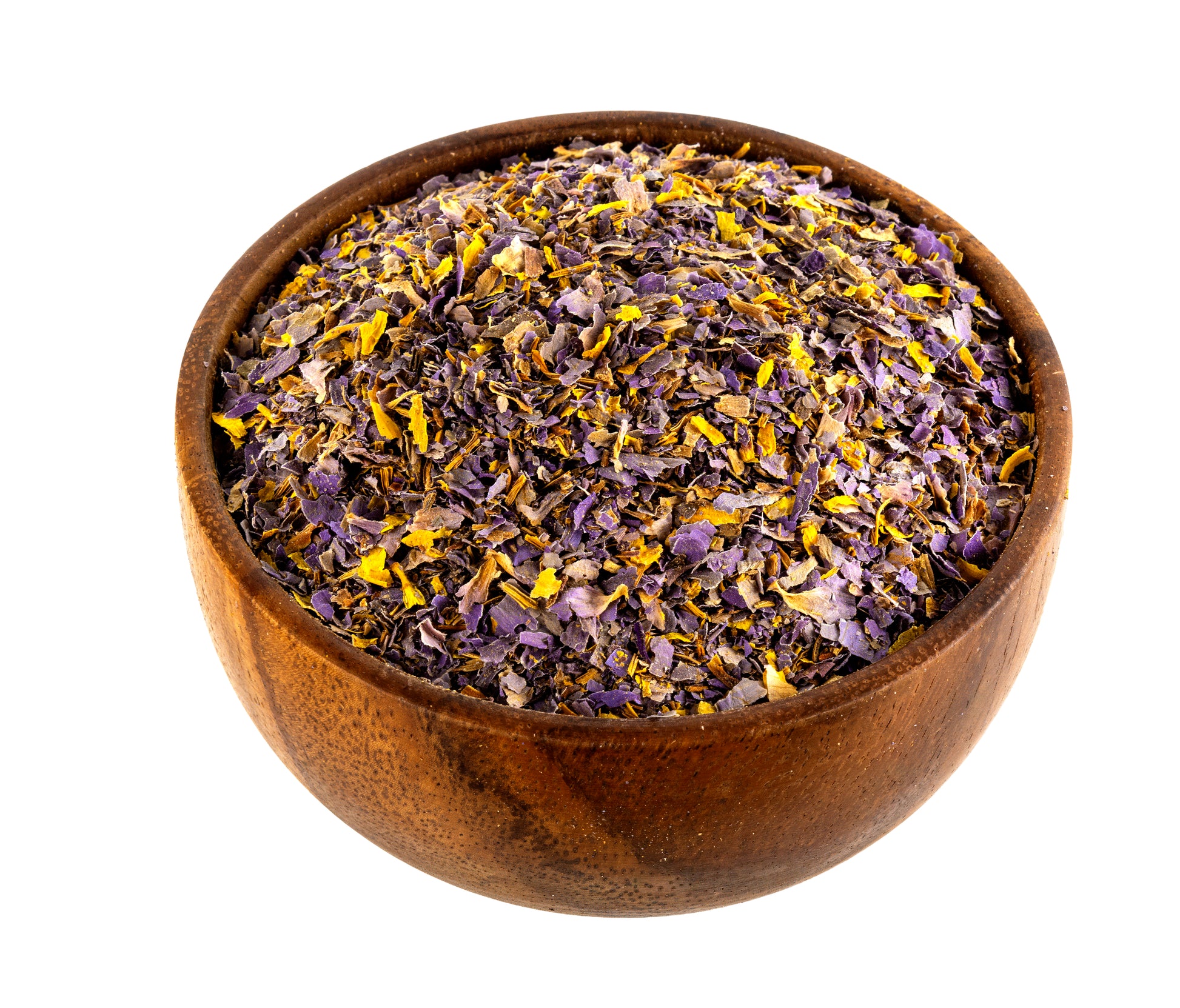 A wooden bowl filled with loose dried blue lotus flower petals, primarily purple and yellow, isolated on a white background.