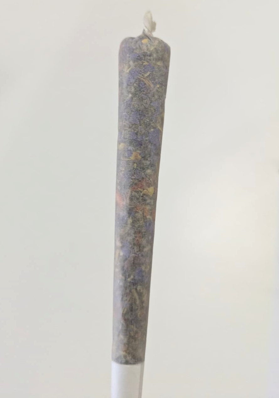 A single herbal cigarette pre rolls on a white background by Astral Herbal.