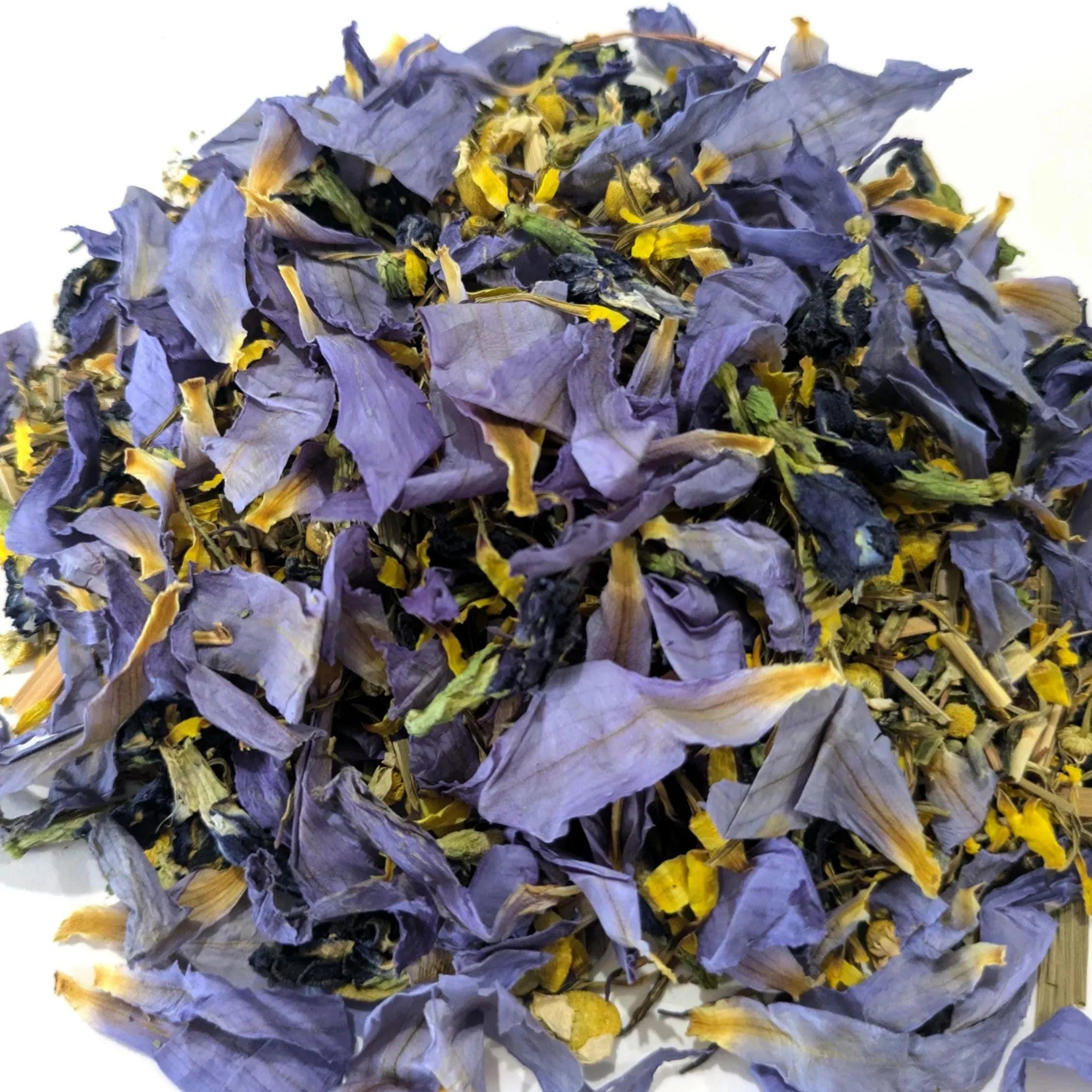 Purple and yellow dried blue lotus and butterfly pea flower petals on a white background