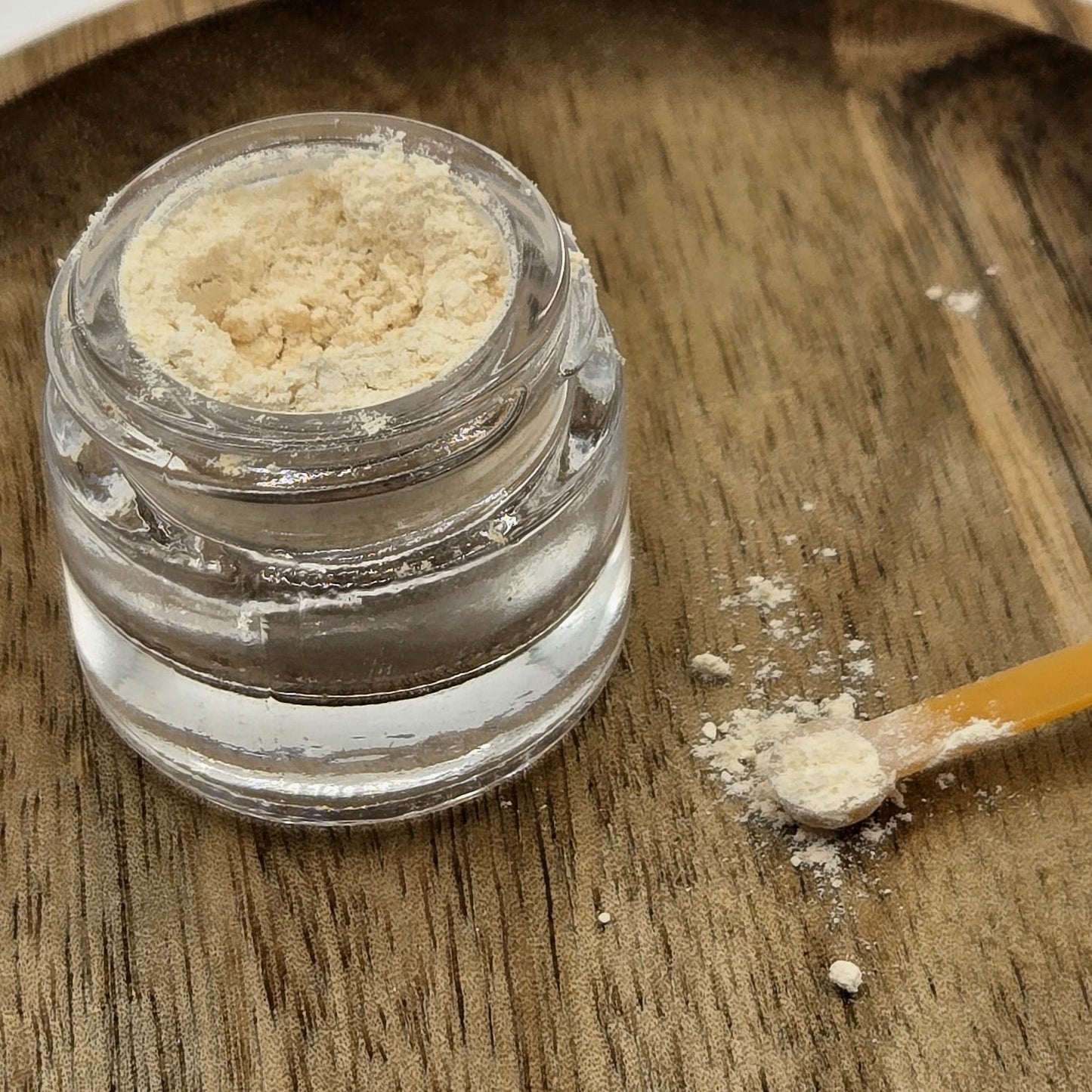 Kanna extract MT-55 in a glass jar on a wooden background by Astral Herbal.