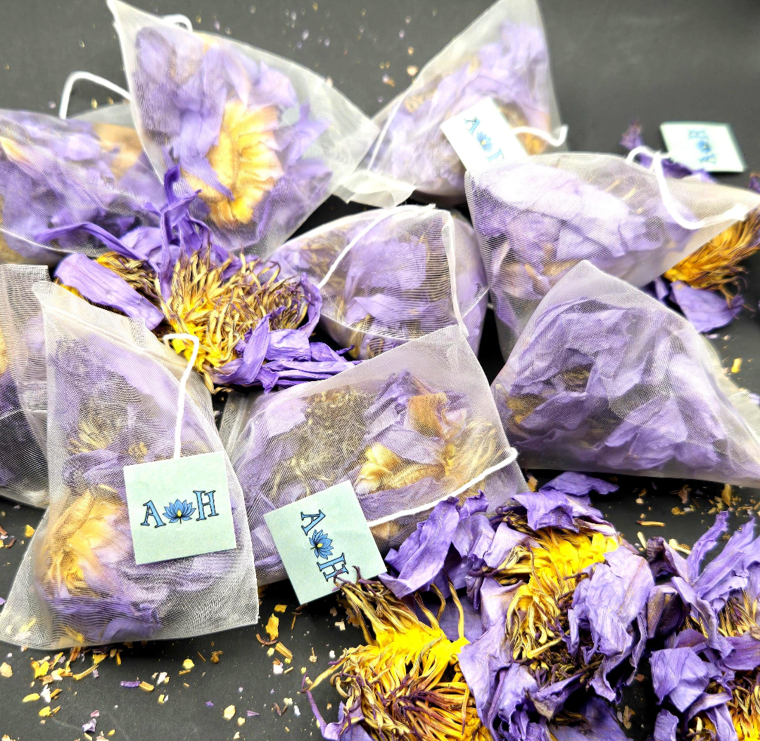 Blue lotus pyramid tea bags by Astral Herbal on a black background.